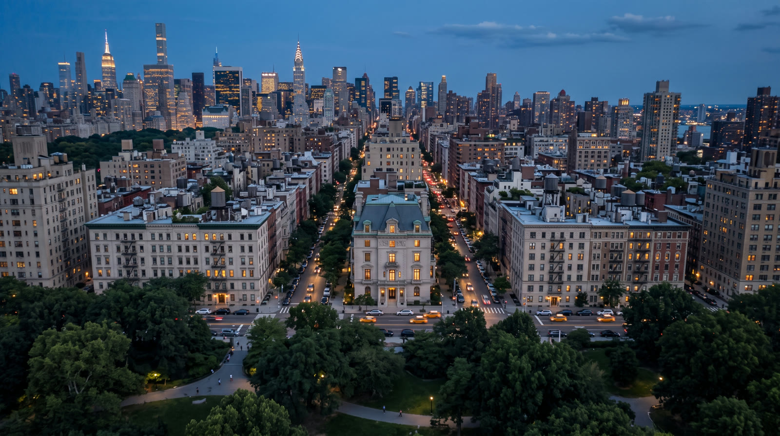 Dusk aerial over Central Park toward the lit limestone mansion and the midtown skyline